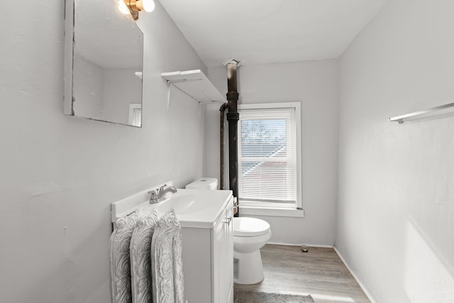 bathroom with vanity, hardwood / wood-style flooring, and toilet