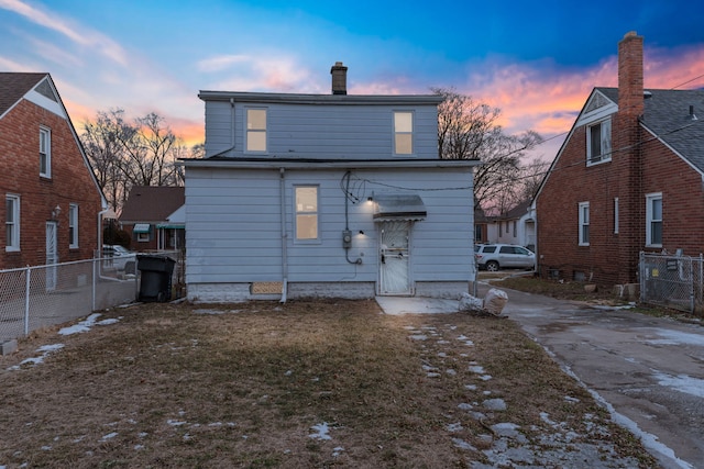 view of back house at dusk