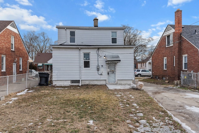 rear view of property featuring a yard