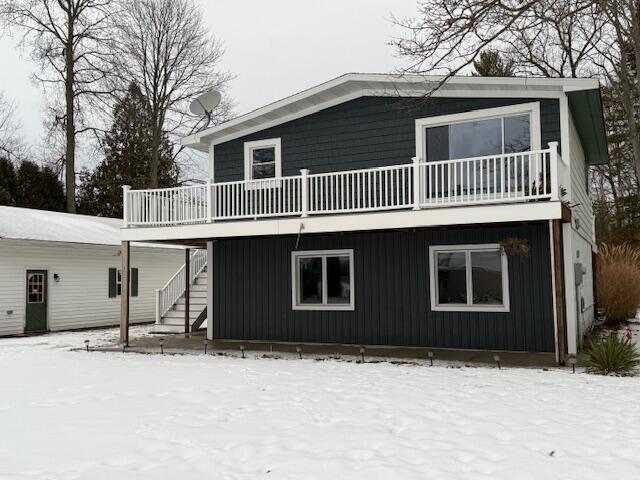 view of snow covered back of property