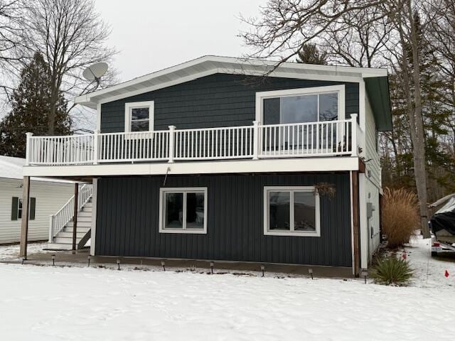 view of snow covered rear of property