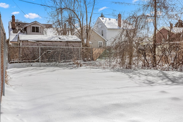 yard layered in snow featuring fence