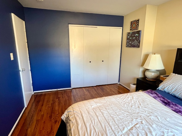 bedroom featuring a closet and dark hardwood / wood-style floors