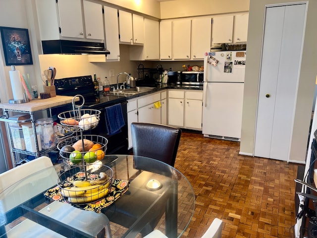 kitchen featuring black / electric stove, sink, white cabinets, and white refrigerator