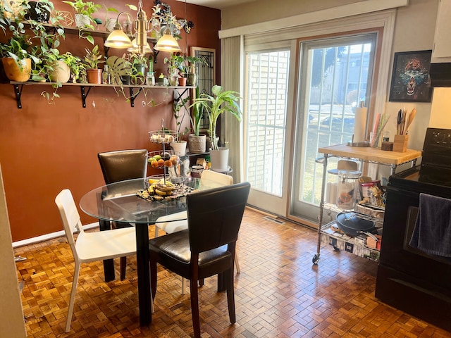 dining area with plenty of natural light and an inviting chandelier