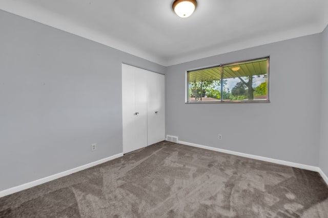 unfurnished bedroom with carpet and a closet