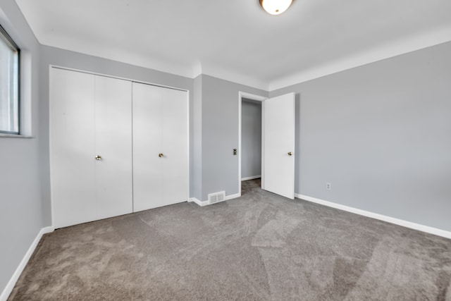 unfurnished bedroom featuring a closet and carpet