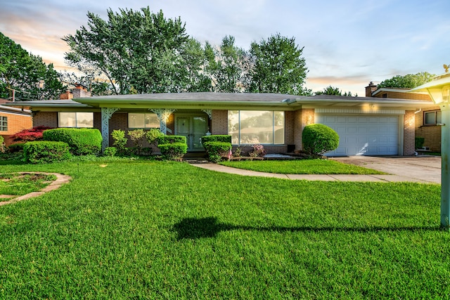 ranch-style home with a garage and a lawn