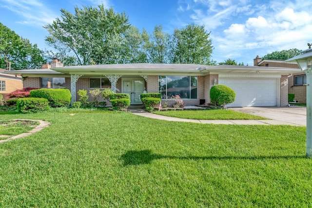 single story home featuring a garage and a front lawn