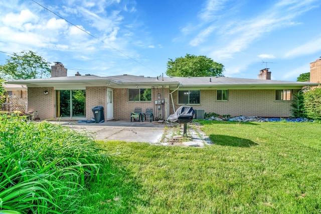 back of property featuring cooling unit, a lawn, and a patio