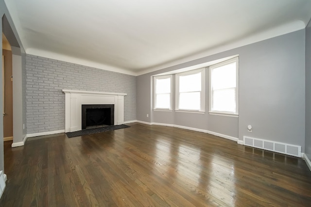 unfurnished living room with dark hardwood / wood-style floors