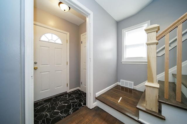 foyer entrance with dark wood-type flooring