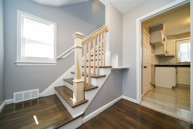 stairs featuring hardwood / wood-style flooring