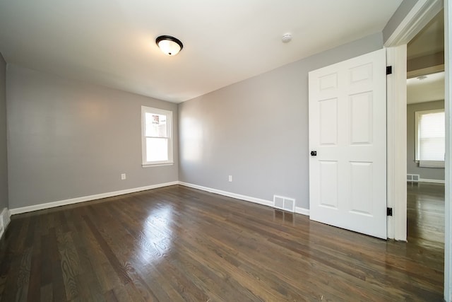 spare room with dark hardwood / wood-style flooring