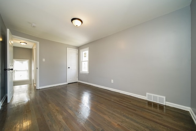 empty room with dark hardwood / wood-style floors