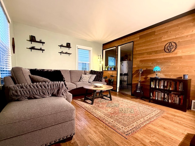 living room featuring wood-type flooring and wood walls