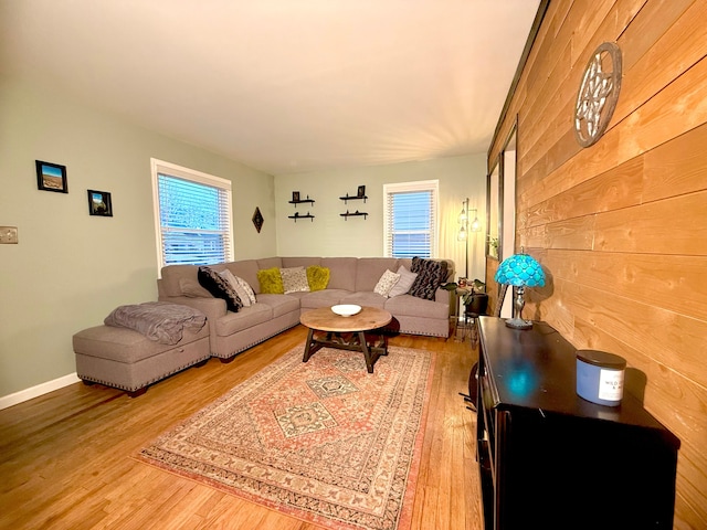 living room featuring hardwood / wood-style floors and wood walls