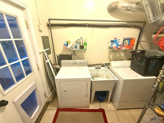 laundry area featuring washing machine and dryer and light tile patterned floors