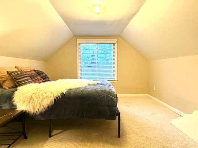 bedroom with lofted ceiling and carpet