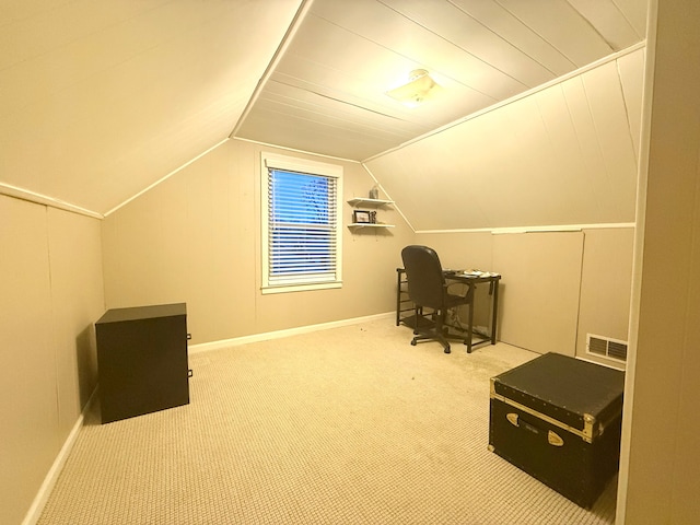 home office with lofted ceiling and carpet