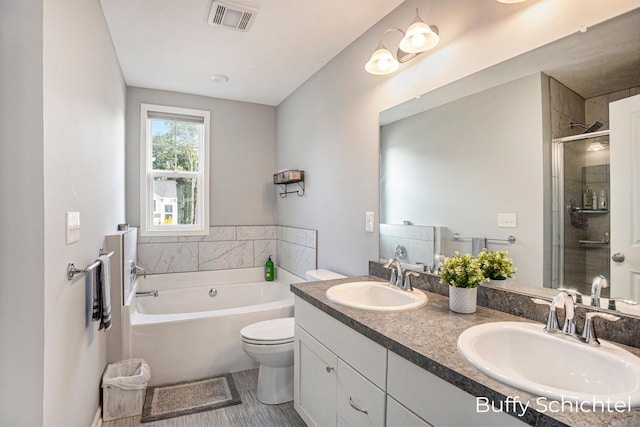 full bathroom with vanity, separate shower and tub, and toilet