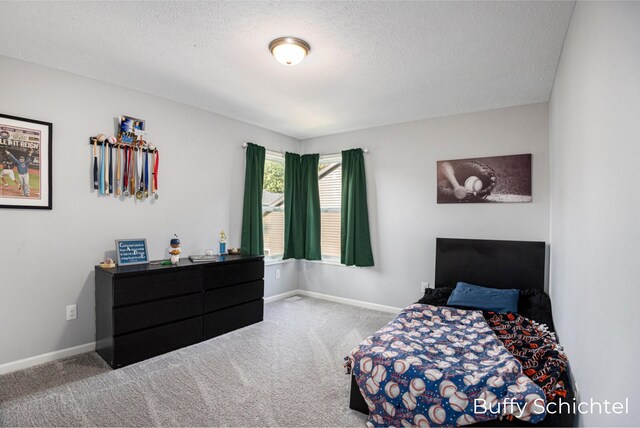 carpeted bedroom featuring a textured ceiling