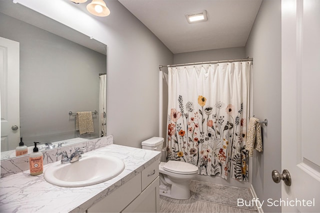 bathroom with vanity, toilet, and a shower with shower curtain