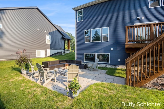 back of property featuring a fire pit, a yard, and a patio