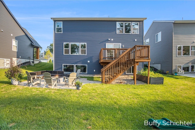 rear view of house with a yard, a deck, and a patio area