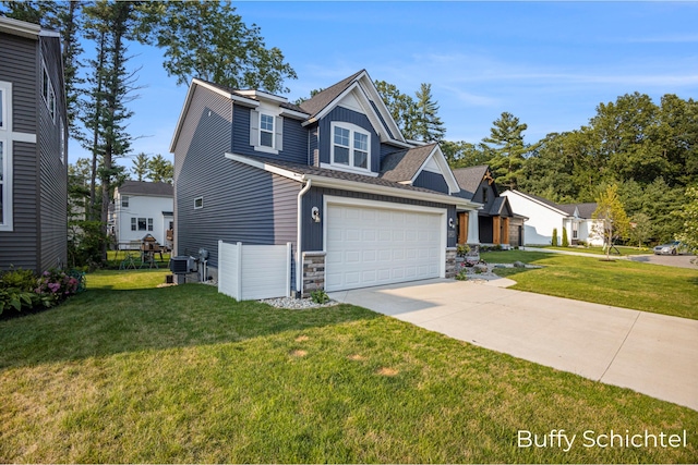 craftsman-style house with a garage and a front lawn