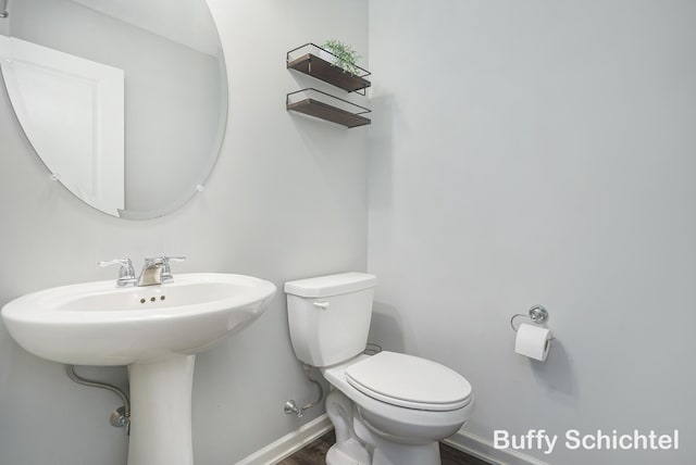 bathroom featuring hardwood / wood-style flooring and toilet