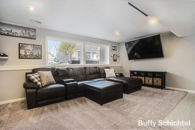 living room featuring carpet floors and a textured ceiling