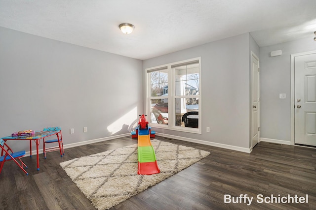 game room featuring dark wood-type flooring