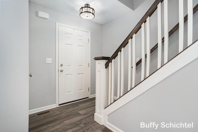 entrance foyer featuring dark wood-type flooring