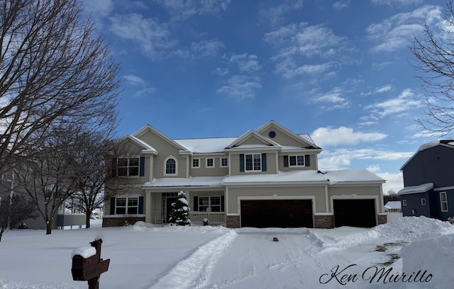 view of front of property featuring a garage and covered porch