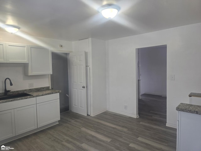 kitchen featuring white cabinetry, sink, and dark hardwood / wood-style flooring