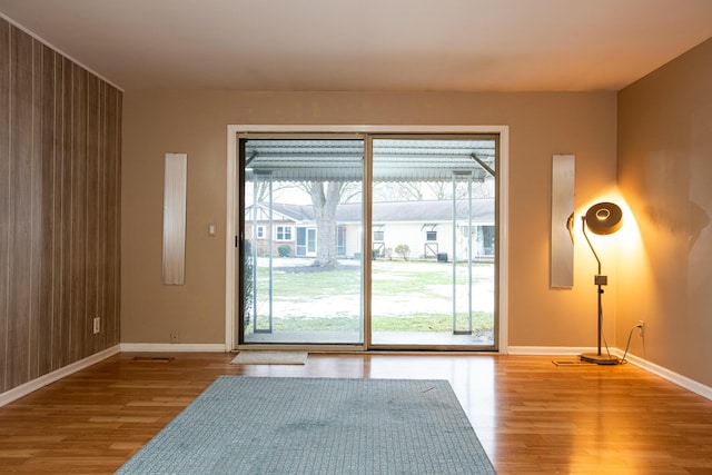 doorway featuring a healthy amount of sunlight and light hardwood / wood-style flooring