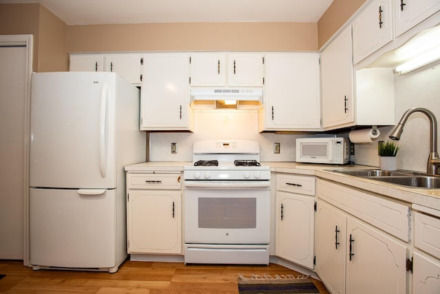 kitchen featuring white cabinetry, sink, white appliances, and light hardwood / wood-style flooring