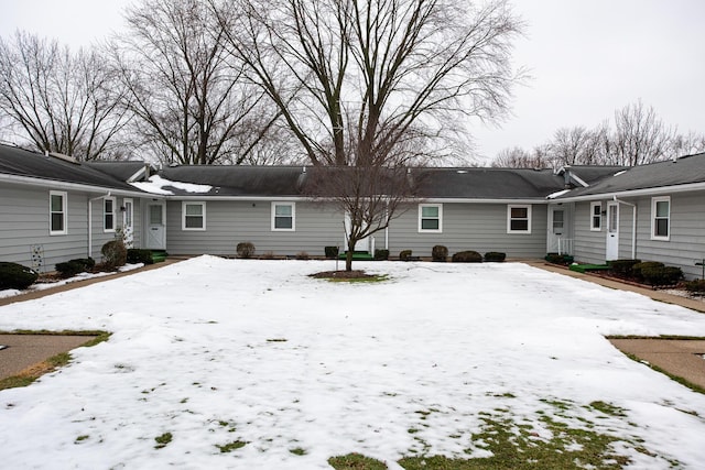 view of snow covered rear of property