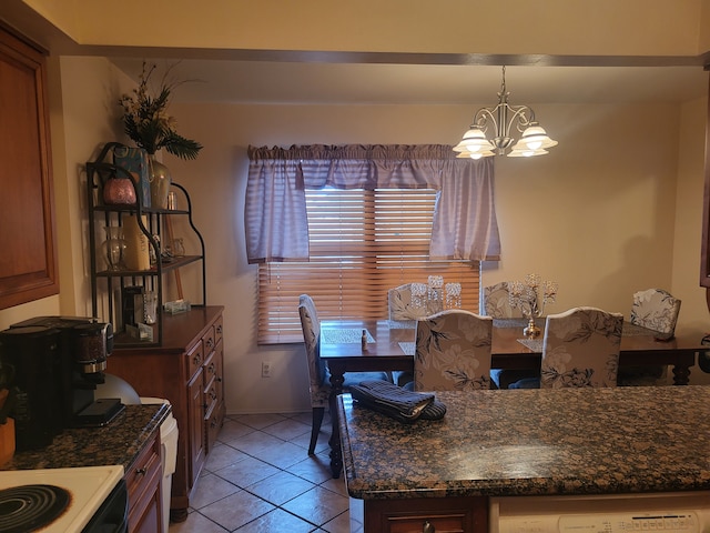 tiled dining space with an inviting chandelier