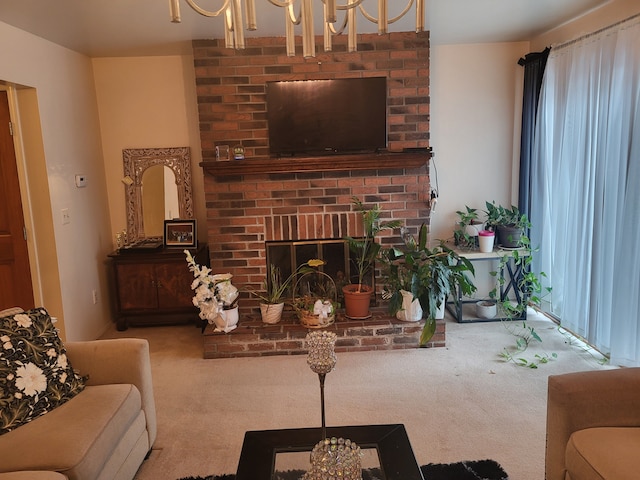 carpeted living room featuring a brick fireplace and a notable chandelier