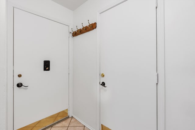entryway with light tile patterned flooring