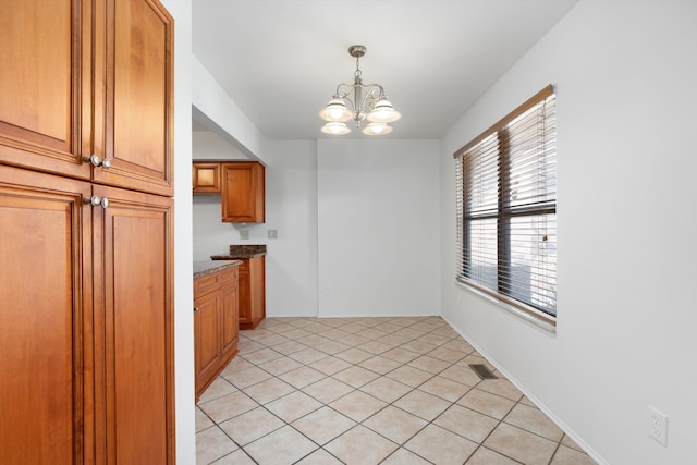 unfurnished dining area with visible vents, a chandelier, and light tile patterned floors