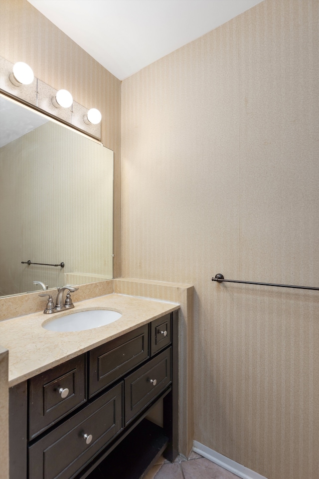 bathroom with tile patterned flooring, vanity, and wallpapered walls