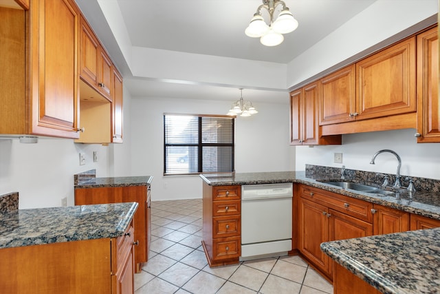 kitchen featuring an inviting chandelier, brown cabinetry, a peninsula, dishwasher, and a sink