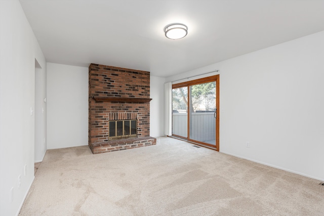 unfurnished living room with carpet and a brick fireplace