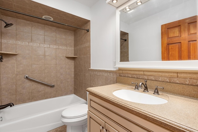 bathroom with toilet, vanity, washtub / shower combination, and tile walls