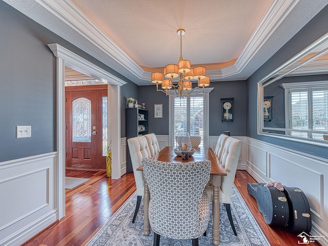 dining area featuring a notable chandelier, a tray ceiling, a textured ceiling, and a wealth of natural light