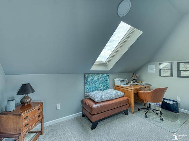 carpeted office space with lofted ceiling with skylight