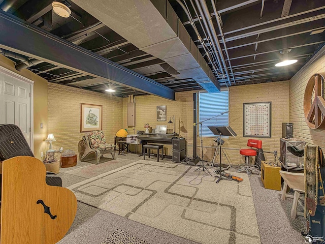 playroom featuring brick wall, carpet floors, and electric panel